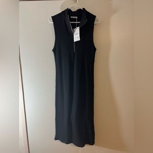 Thick material. Zipper front. Never worn dress with tags